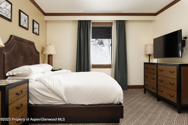 bedroom featuring crown molding and dark colored carpet