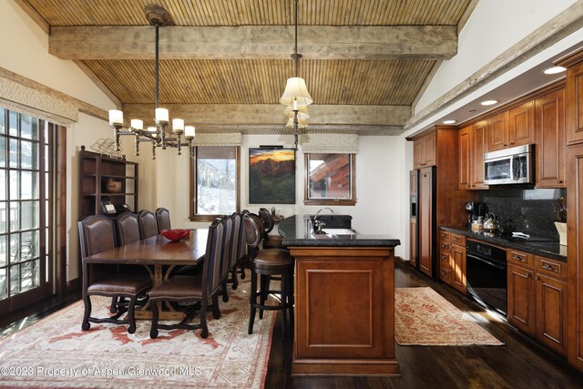 dining area with plenty of natural light, dark hardwood / wood-style floors, and wooden ceiling