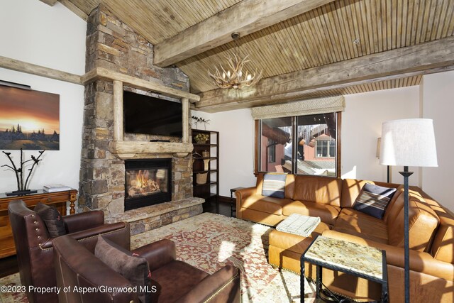 living room featuring a stone fireplace, an inviting chandelier, wooden ceiling, and vaulted ceiling with beams