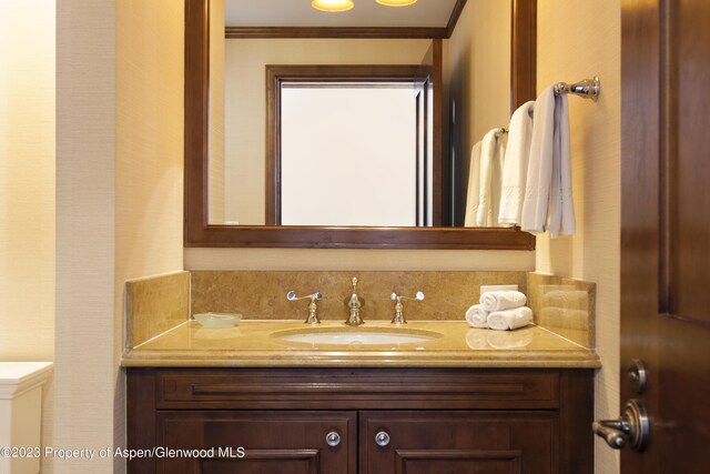 bathroom with vanity and ornamental molding