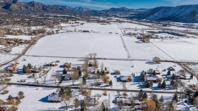 snowy aerial view featuring a mountain view