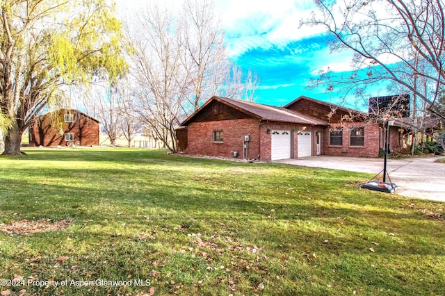 view of home's exterior with a yard and a garage