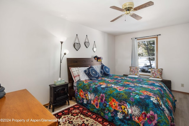 bedroom featuring hardwood / wood-style flooring and ceiling fan