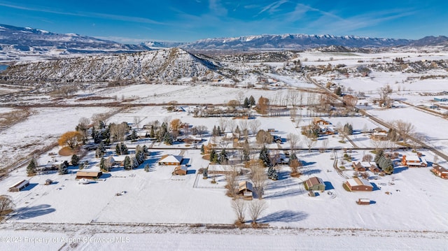 snowy aerial view with a mountain view