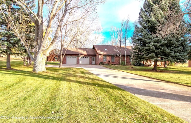 ranch-style house featuring a front yard and a garage