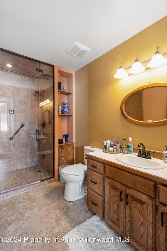 bathroom with vanity, an enclosed shower, and toilet