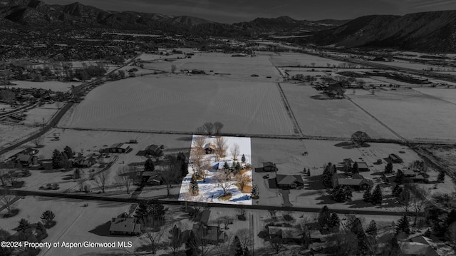 snowy aerial view featuring a mountain view