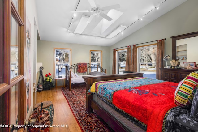 bedroom featuring light hardwood / wood-style flooring, vaulted ceiling, and ceiling fan