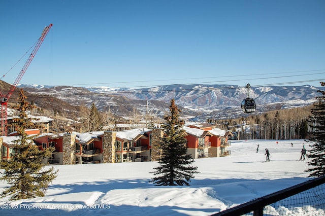 snowy yard featuring a mountain view