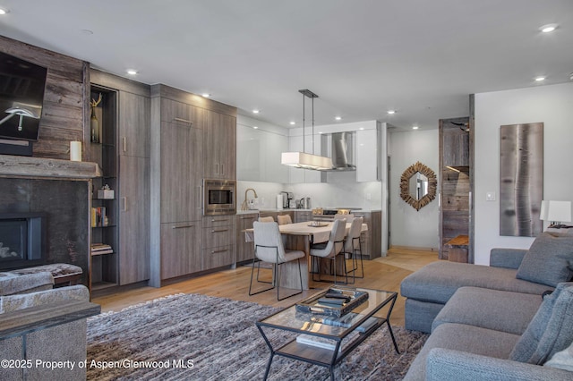 living room with sink and light hardwood / wood-style floors