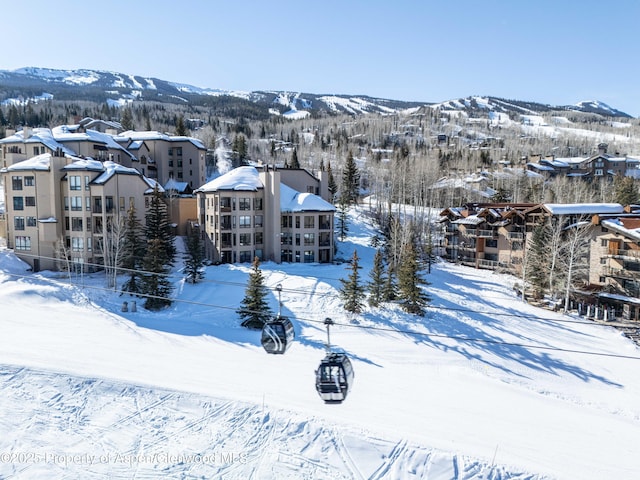 snowy aerial view with a mountain view