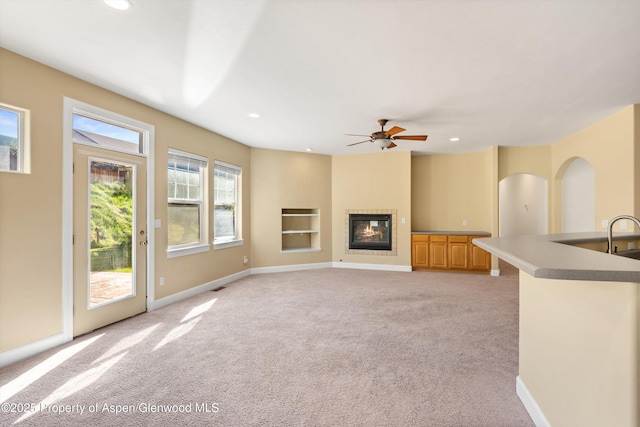 440 Stage Coach Ln, New Castle, CO 81647 - unfurnished living room featuring light colored carpet, a glass covered fireplace, and recessed lighting