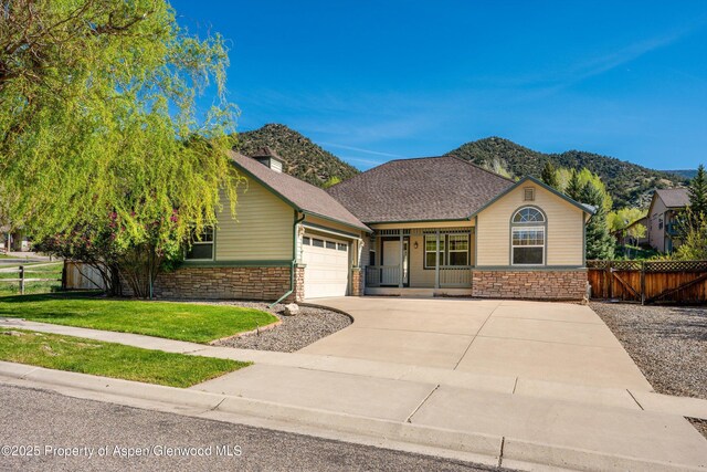 440 Stage Coach Ln, New Castle, CO 81647 - ranch-style home featuring fence, an attached garage, stone siding, driveway, and a front yard