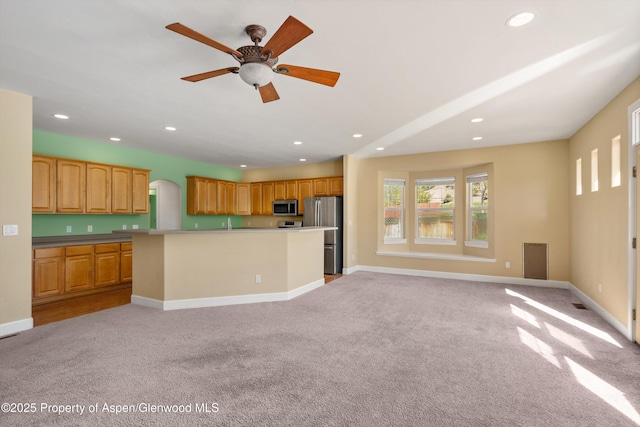 440 Stage Coach Ln, New Castle, CO 81647 - kitchen with stainless steel appliances, open floor plan, light carpet, a kitchen island, and recessed lighting