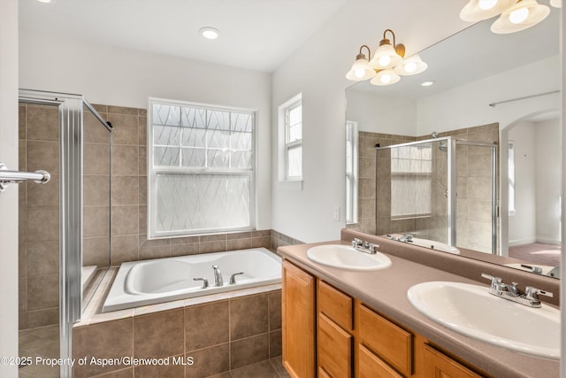 440 Stage Coach Ln, New Castle, CO 81647 - bathroom featuring double vanity, a bath, a shower stall, and a sink