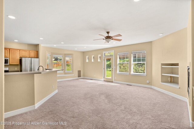 440 Stage Coach Ln, New Castle, CO 81647 - unfurnished living room with baseboards, built in features, recessed lighting, and light colored carpet
