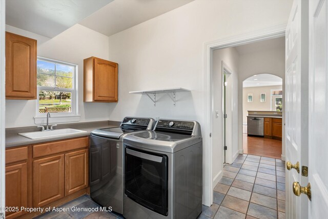 440 Stage Coach Ln, New Castle, CO 81647 - clothes washing area with washer and clothes dryer, cabinet space, a sink, and arched walkways