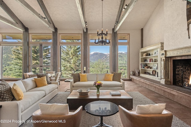 sunroom featuring a mountain view, an inviting chandelier, and plenty of natural light