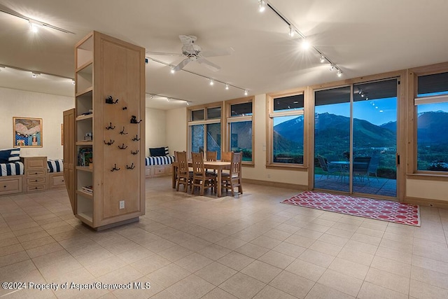 interior space with a mountain view, ceiling fan, and light tile patterned flooring