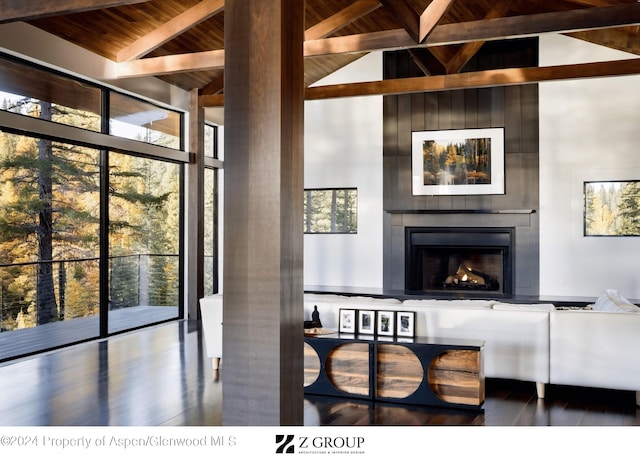 interior space featuring beamed ceiling, wood ceiling, a fireplace, and hardwood / wood-style flooring