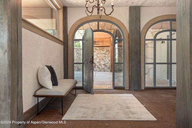 entrance foyer featuring french doors and an inviting chandelier