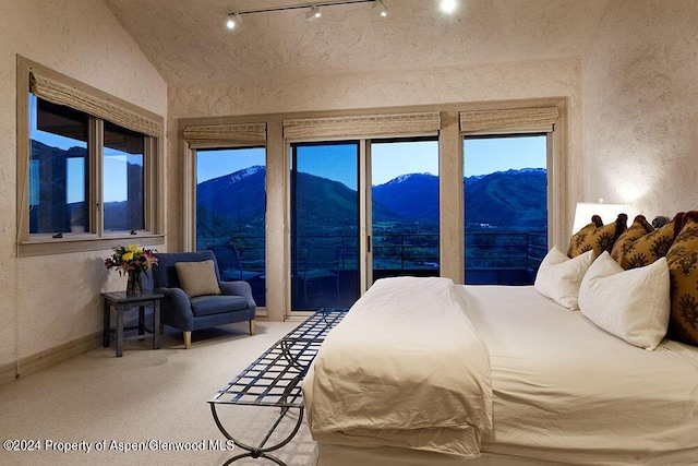 bedroom with carpet flooring, a mountain view, and lofted ceiling