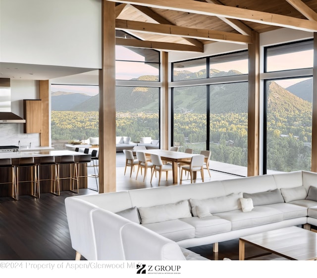 living room featuring wood ceiling, a mountain view, a healthy amount of sunlight, and dark hardwood / wood-style floors