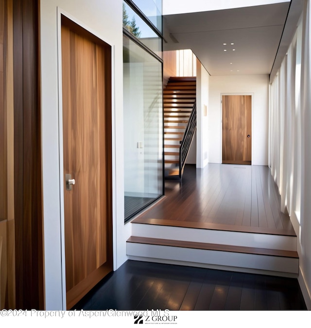 stairway featuring wood-type flooring