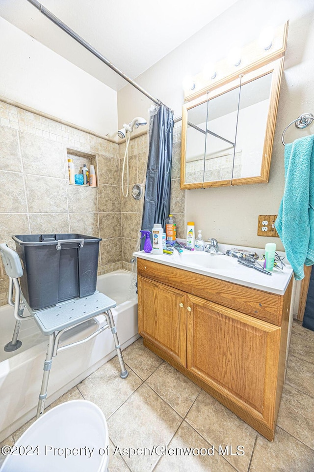 full bathroom with vanity, shower / bath combination with curtain, tile patterned flooring, toilet, and tile walls