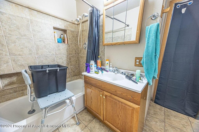 bathroom featuring vanity, tile patterned flooring, shower / bathtub combination with curtain, and tile walls