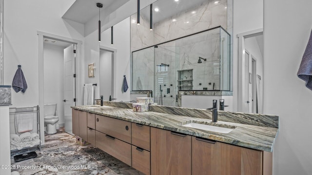 63 Meadow Creek Ct, Battlement Mesa, CO 81635 - bathroom with marble finish floor, double vanity, toilet, a sink, and a stall shower