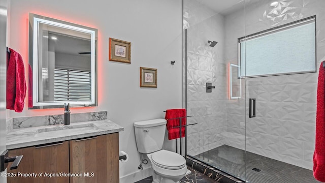 63 Meadow Creek Ct, Battlement Mesa, CO 81635 - bathroom with marble finish floor, toilet, vanity, baseboards, and a stall shower