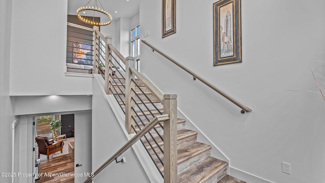 63 Meadow Creek Ct, Battlement Mesa, CO 81635 - stairway featuring a towering ceiling and an inviting chandelier