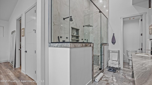 63 Meadow Creek Ct, Battlement Mesa, CO 81635 - bathroom featuring baseboards, toilet, and a stall shower