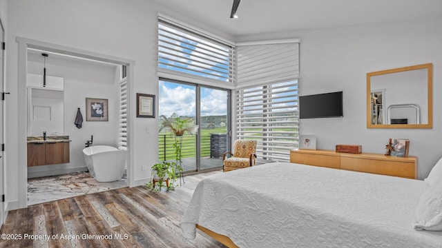 63 Meadow Creek Ct, Battlement Mesa, CO 81635 - bedroom featuring access to outside, wood finished floors, and a towering ceiling