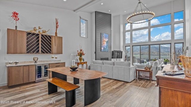 63 Meadow Creek Ct, Battlement Mesa, CO 81635 - interior space featuring recessed lighting, beverage cooler, a high ceiling, light wood-type flooring, and a notable chandelier