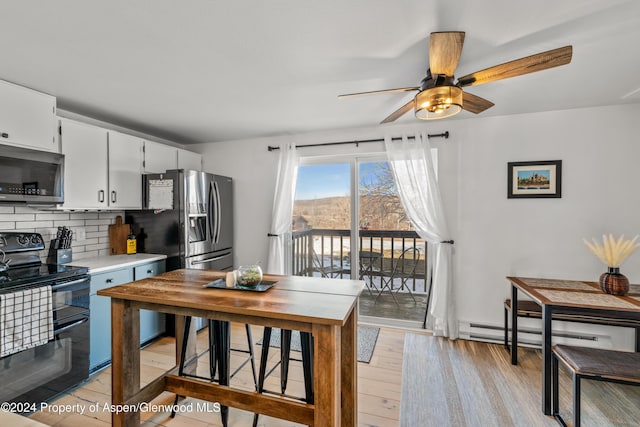 kitchen with white cabinetry, ceiling fan, backsplash, light hardwood / wood-style floors, and appliances with stainless steel finishes