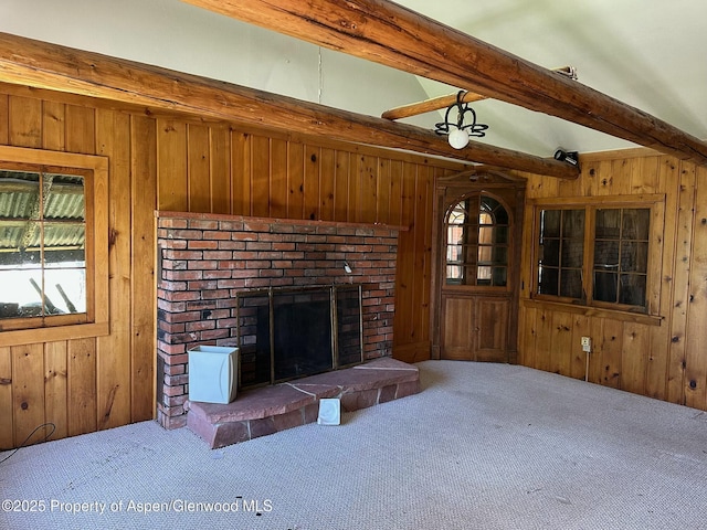 15405 Frying Pan Rd, Basalt, CO 81621 - living room featuring wood walls, beamed ceiling, healthy amount of natural light, carpet flooring, and a brick fireplace