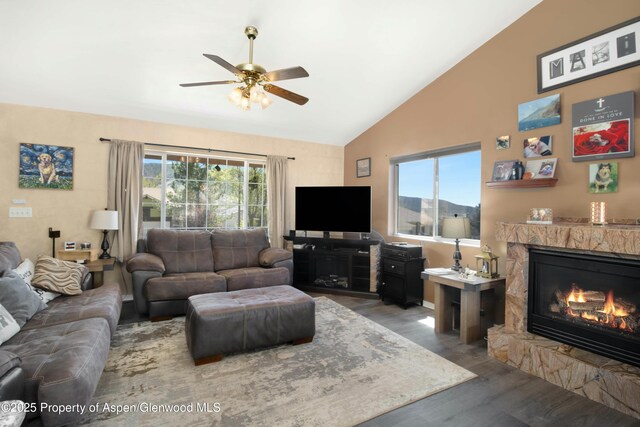31 Hawthorne Way, Parachute, CO 81635 - living room with a glass covered fireplace, vaulted ceiling, wood finished floors, and a ceiling fan