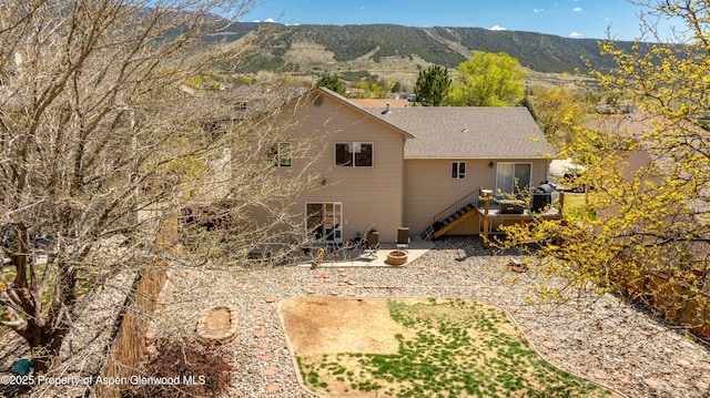31 Hawthorne Way, Parachute, CO 81635 - rear view of property featuring central AC unit, a deck with mountain view, a shingled roof, a patio, and stairs