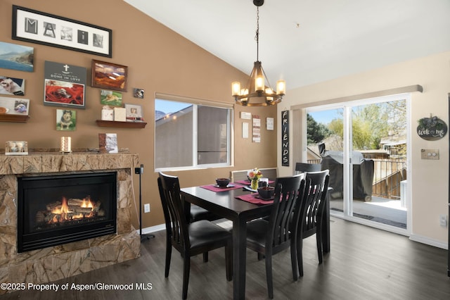 31 Hawthorne Way, Parachute, CO 81635 - dining room with vaulted ceiling, wood finished floors, baseboards, a chandelier, and a glass covered fireplace