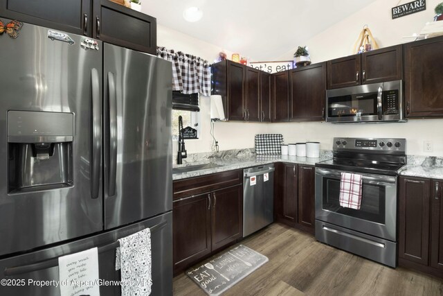 31 Hawthorne Way, Parachute, CO 81635 - kitchen featuring dark brown cabinets, wood finished floors, appliances with stainless steel finishes, and a sink