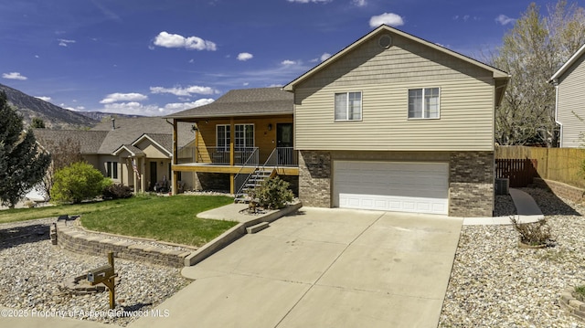 31 Hawthorne Way, Parachute, CO 81635 - tri-level home featuring a porch, driveway, brick siding, and a garage