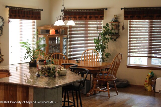 dining space with wood finished floors and baseboards