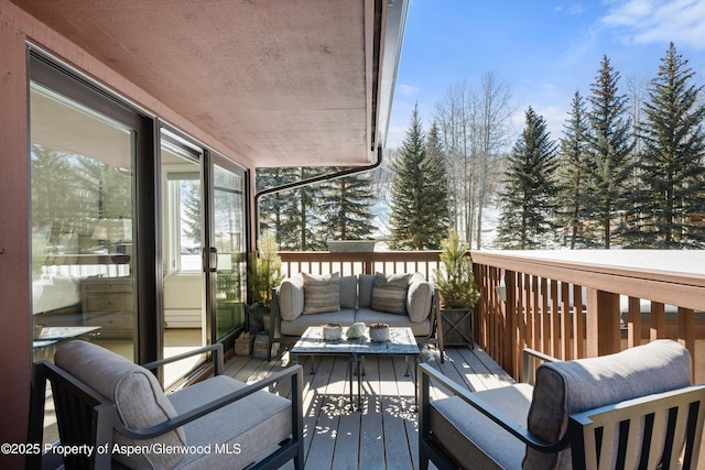 wooden terrace featuring an outdoor living space