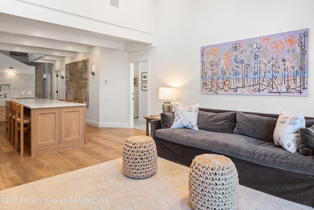 living room featuring light wood-style flooring and baseboards