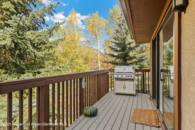 wooden deck featuring a grill