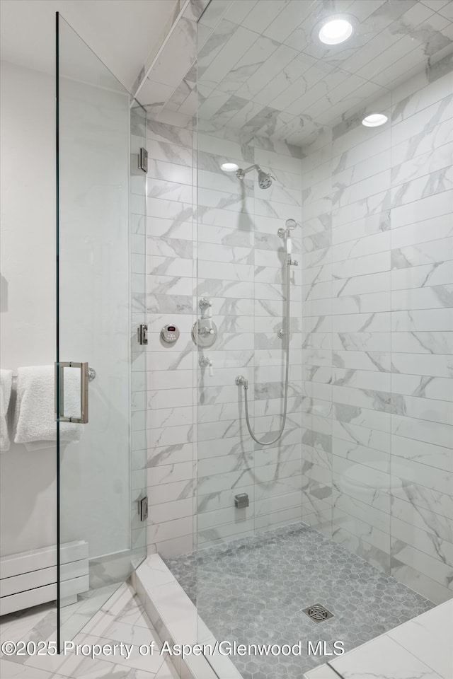 full bath with a stall shower and marble finish floor