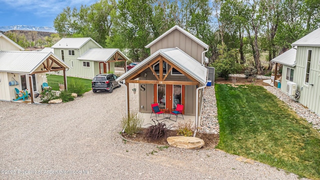 329 River Frontage Rd # 14, Silt, CO 81652 - view of front of home featuring driveway, board and batten siding, a front yard, and ac unit