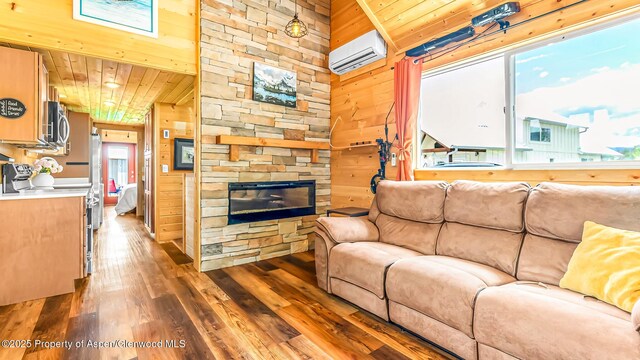 329 River Frontage Rd # 14, Silt, CO 81652 - living area featuring an AC wall unit, wood-type flooring, wood ceiling, wooden walls, and a fireplace